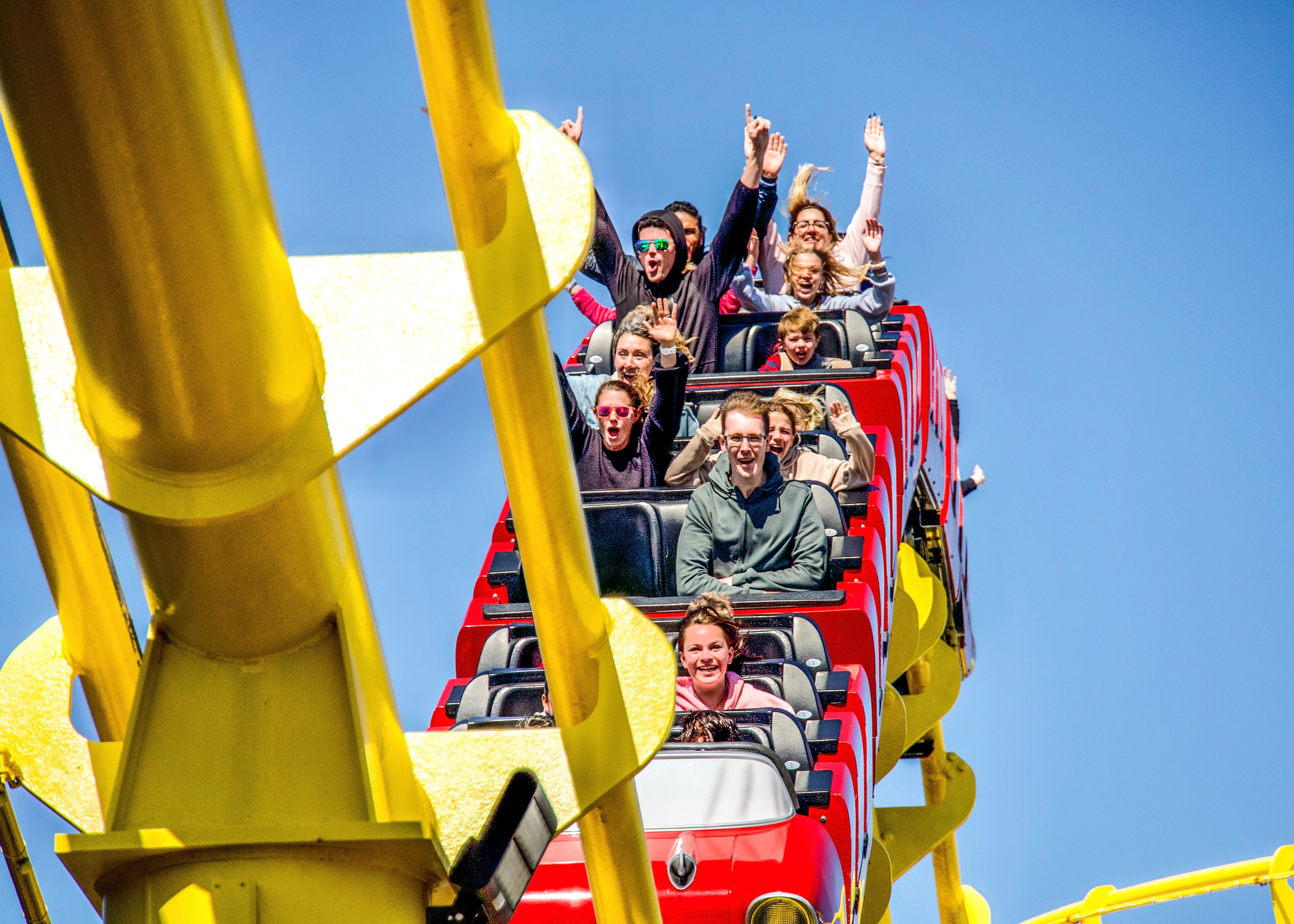 Family riding a roller coaster at a Denver, Colorado amusement park